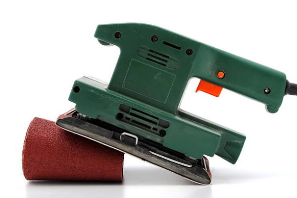 Green wood sander with sandpaper roll isolated on white background